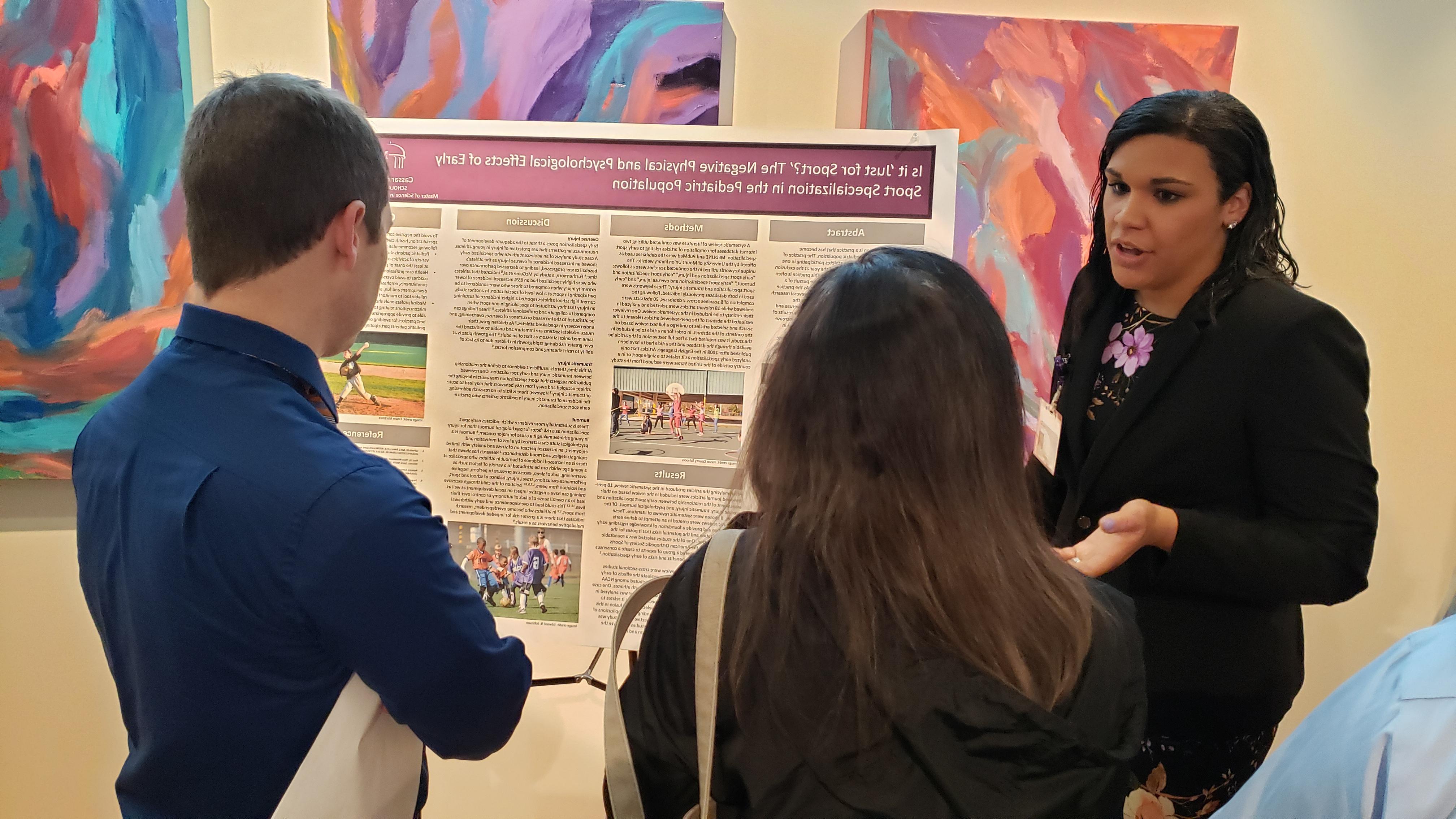 A student presenting a research poster during SCHOLAR Day 2019